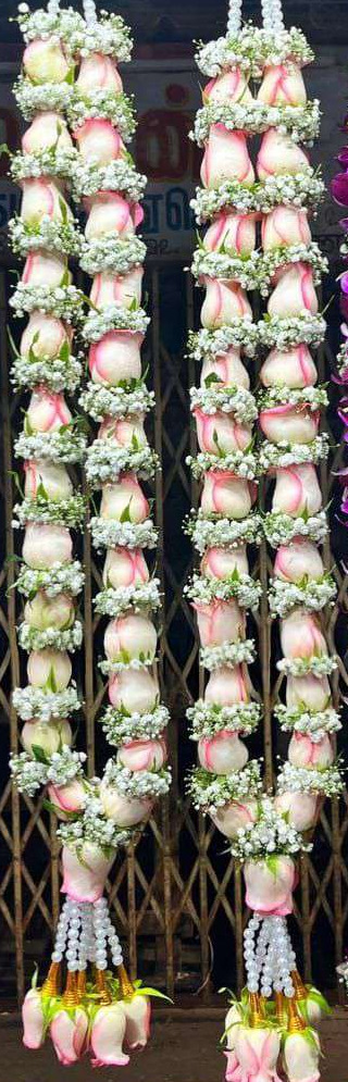 Pair of pink-edged white rose garlands with baby's breath, pearl hangers and gold-cone rose tassels.