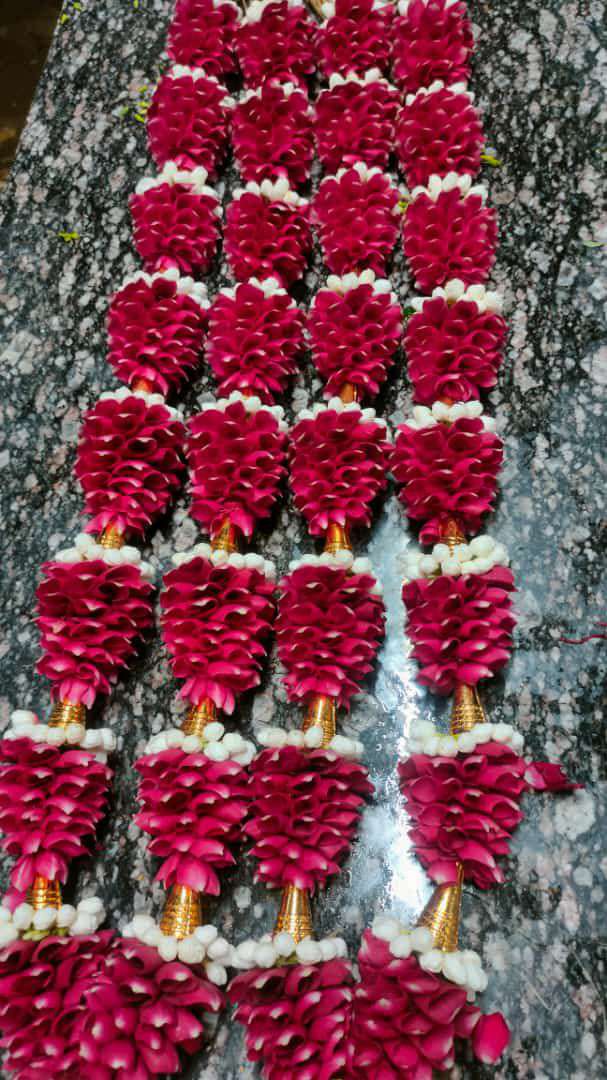 Tiered red rose petal sections with white and gold trim, laid flat.