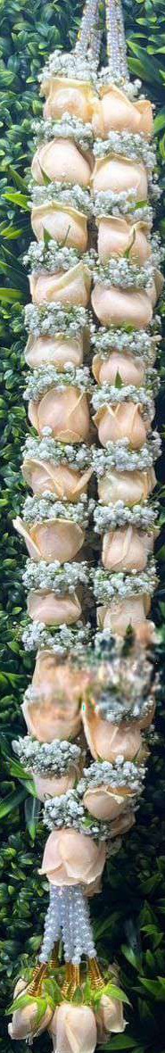 Peach rose garland with baby's breath rings, pearl strands and gold-cone peach rose tassels.