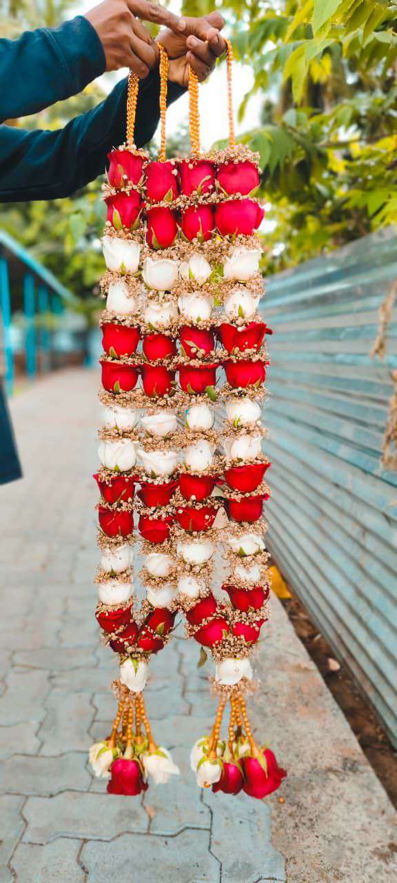 Pair of garlands with alternating blocks of red and white roses, gold bead hangers and rose tassels.