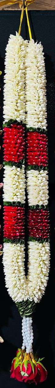 White tuberose garland with red blocks, pearl strands and red rose tassels.