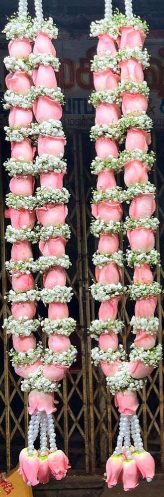 Pair of pink rose garlands with baby's breath rings, pearl hangers and pink rose tassels.