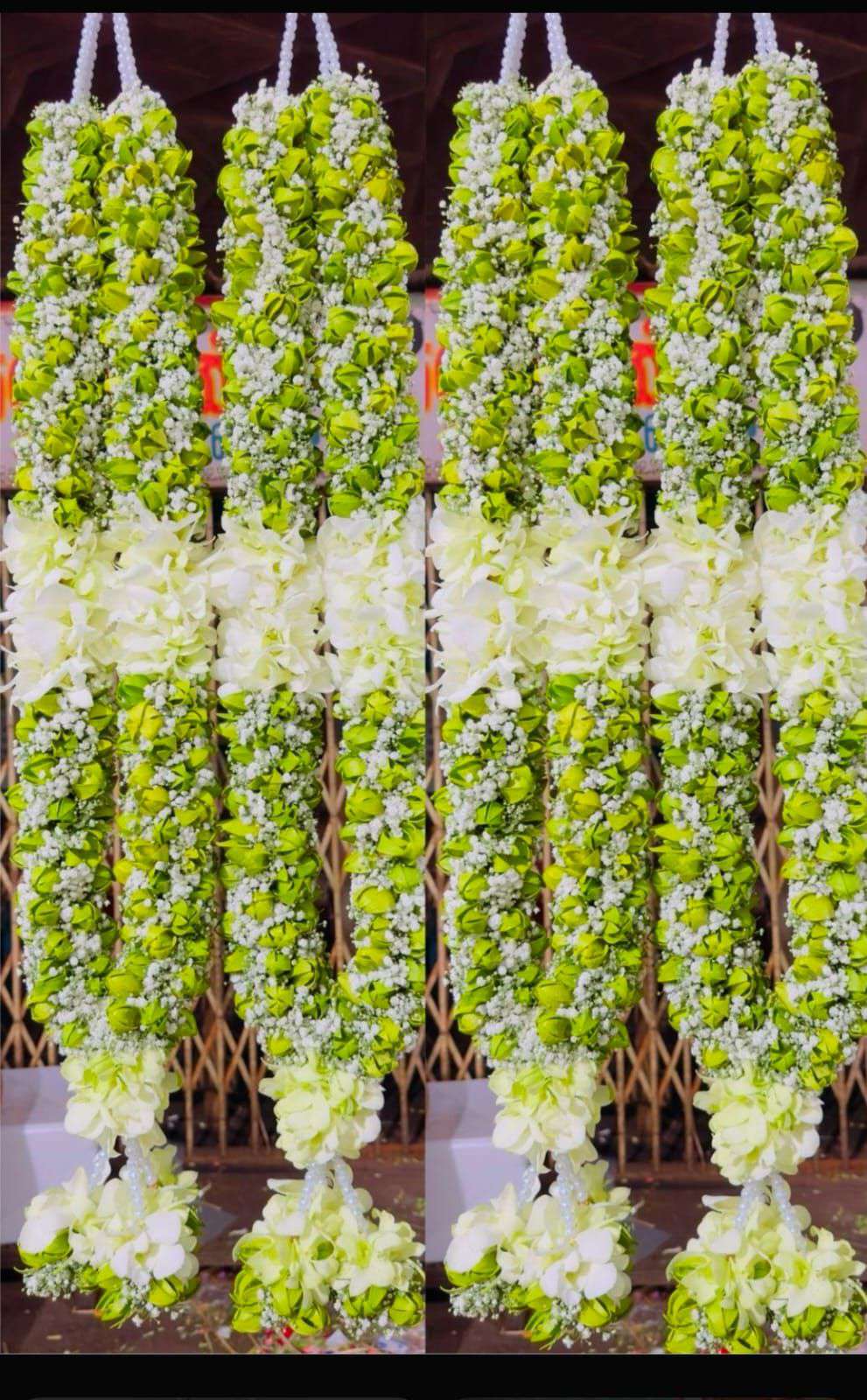Lime green garlands with white orchid sections and white orchid tassels.