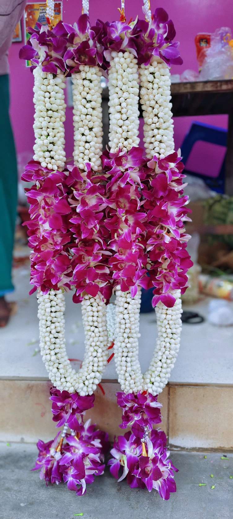 Pair of jasmine garlands with a purple orchid section and purple orchid tassels.