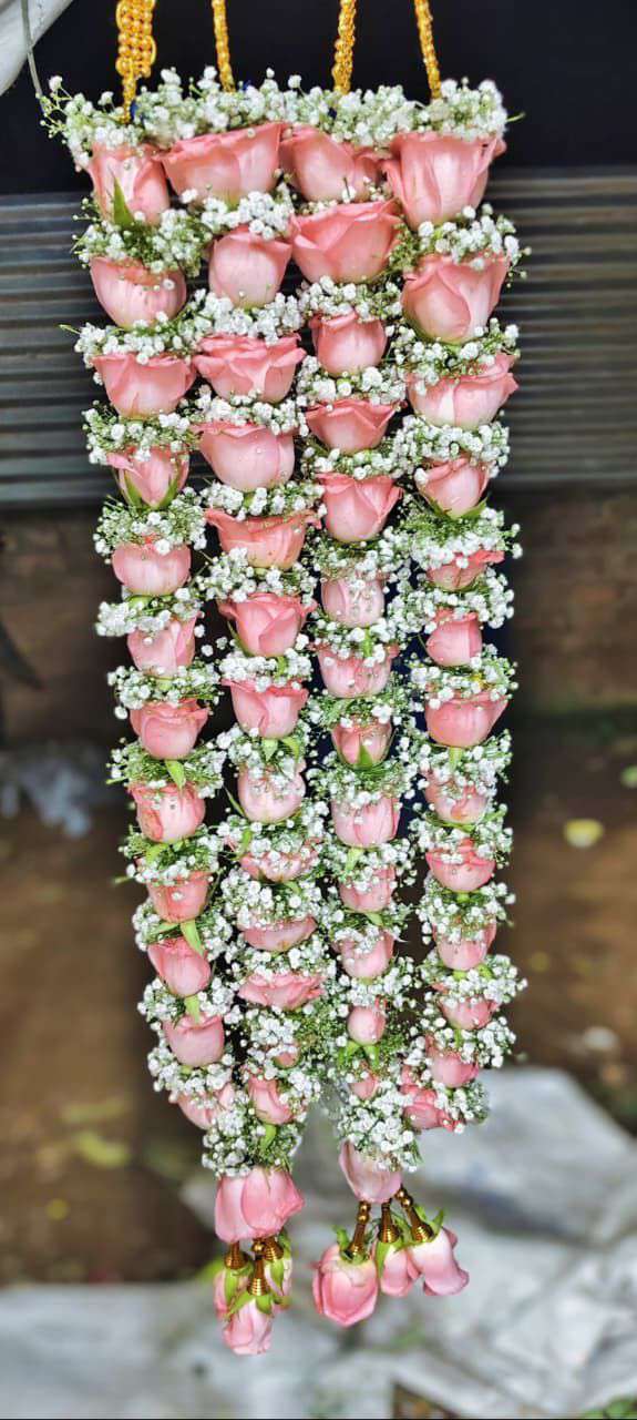 Blush pink rose garlands with fine white floral bands and pink rose tassels.
