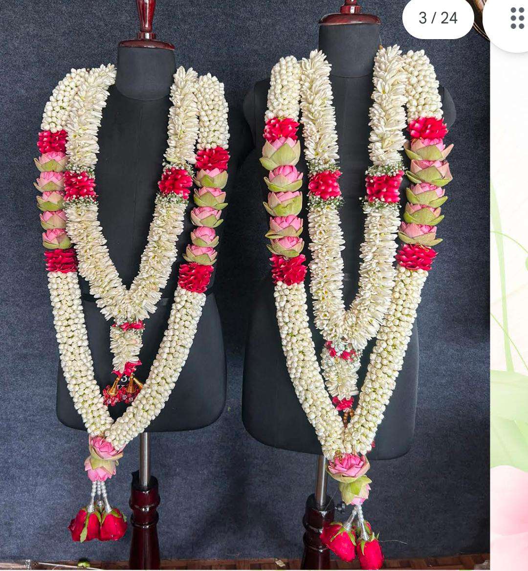 Pair of jasmine garlands with red rose and pink lotus accents, displayed on mannequins.