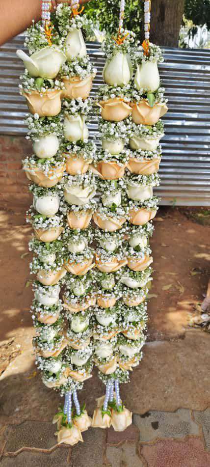 Pair of white and peach rose garlands with baby's breath, pearl hangers and peach rose tassels.