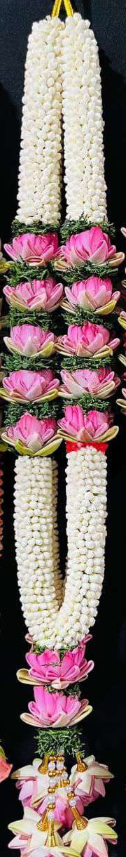 Jasmine garland with pink lotus and green leaf sections and lotus tassels.