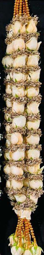 Garland of ivory roses ringed with golden-toned baby's breath, with gold bead tassels.