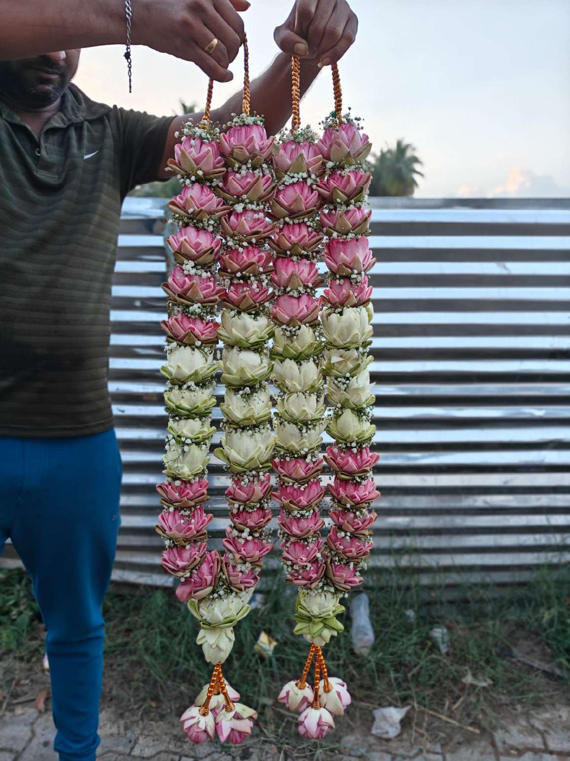 Pair of lotus garlands with pink and ivory sections, gold bead hangers and lotus tassels.