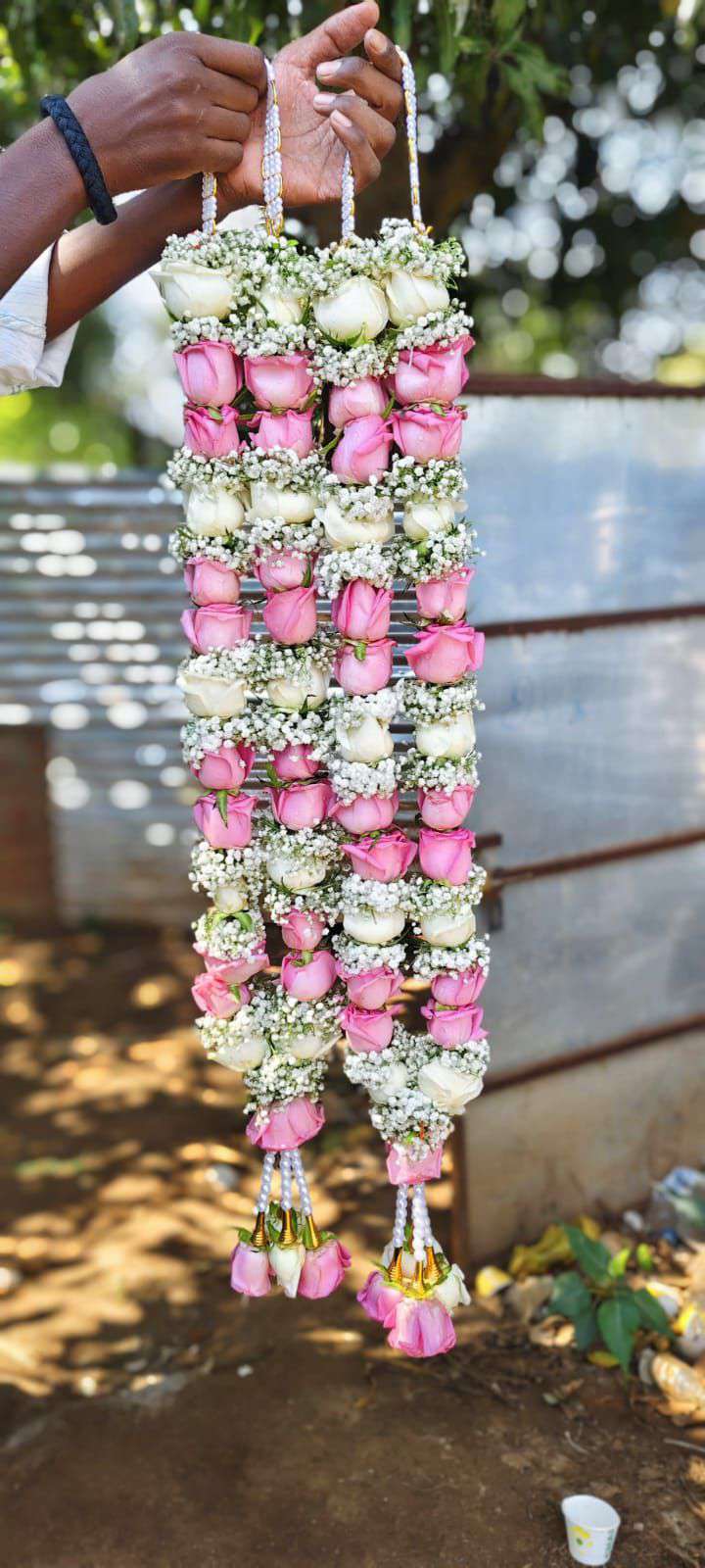 Pair of pink and white rose garlands with baby's breath, pearl hangers and pink rose tassels.