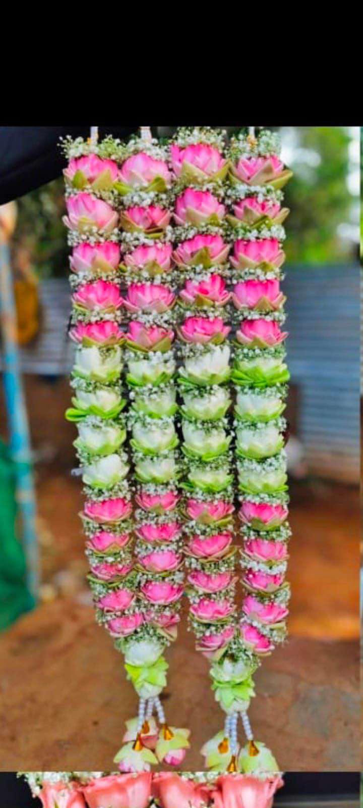 Garland of pink lotus, white lotus and pink lotus sections with baby's breath and lotus tassels.