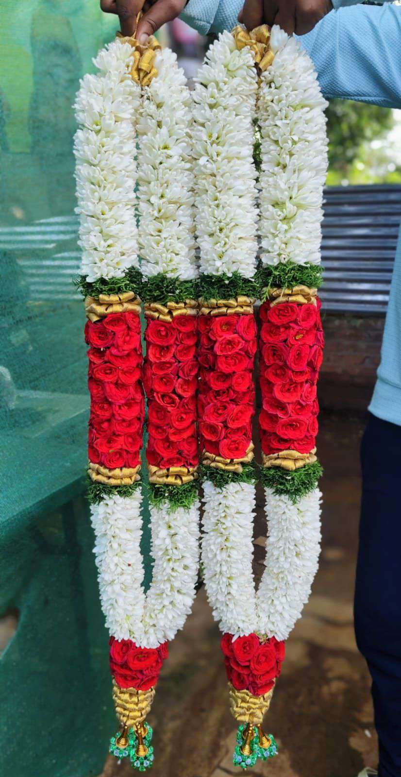 White garlands with a broad red floral centre and green separators.
