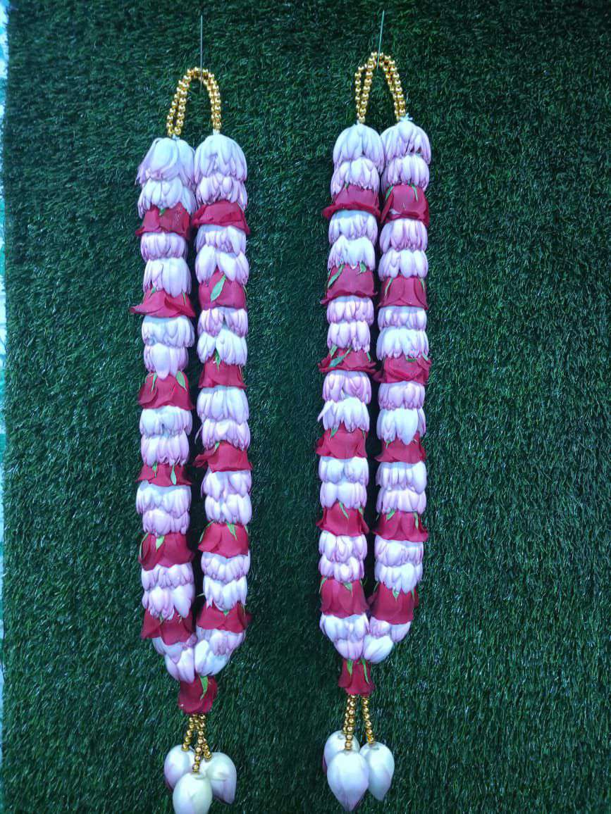 Pair of garlands of white lotus buds and red roses with gold bead hangers and white bud tassels.